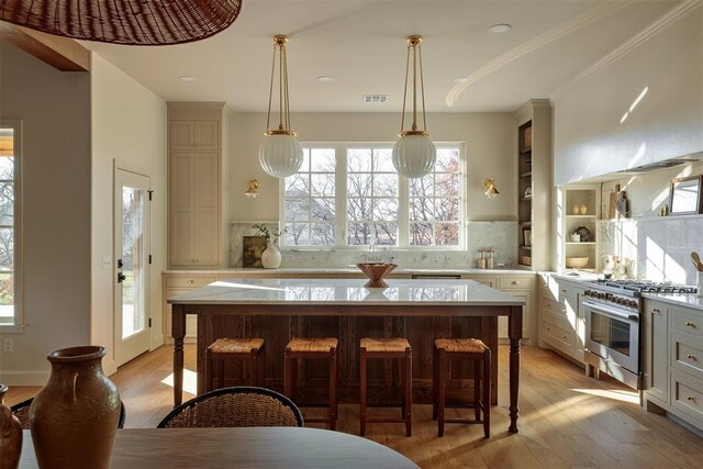 3817 Shady Hill Trl, Edmond, OK 73034 - kitchen featuring high end stainless steel range, decorative backsplash, light wood-style floors, a kitchen island, and recessed lighting