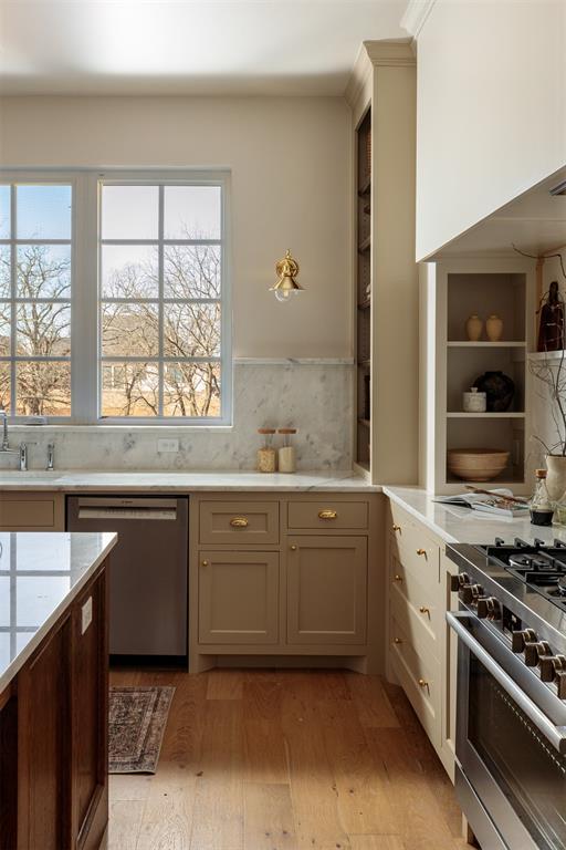 3817 Shady Hill Trl, Edmond, OK 73034 - kitchen with stainless steel appliances, light wood finished floors, a sink, and tasteful backsplash
