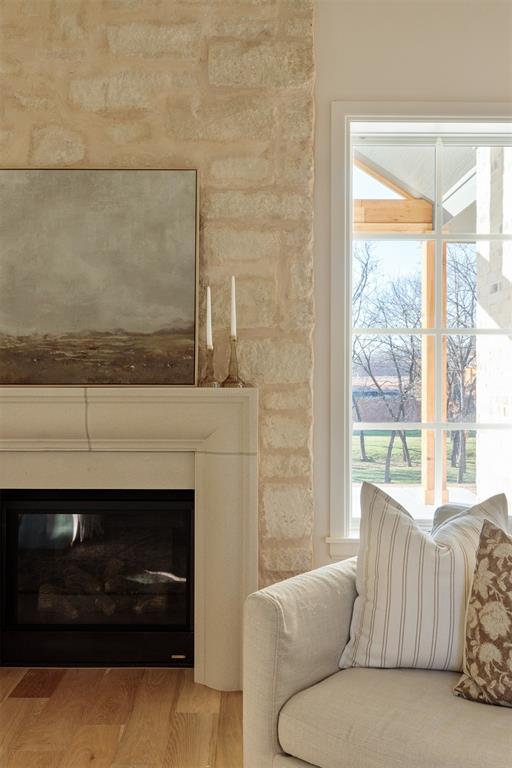 3817 Shady Hill Trl, Edmond, OK 73034 - living room featuring wood finished floors and a glass covered fireplace