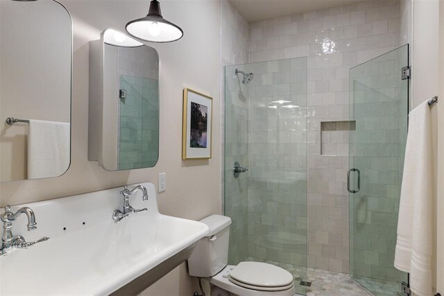3817 Shady Hill Trl, Edmond, OK 73034 - bathroom featuring a shower stall, toilet, and a sink