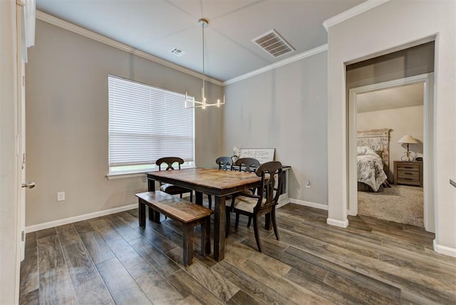 715 SE 37th St, Newcastle, OK 73065 - dining area with ornamental molding, dark wood-style flooring, a chandelier, and baseboards