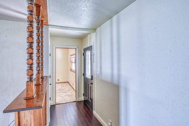 1110 Lollar Dr, Maysville, OK 73057 - doorway to outside with a textured wall, dark wood-style floors, baseboards, and a textured ceiling