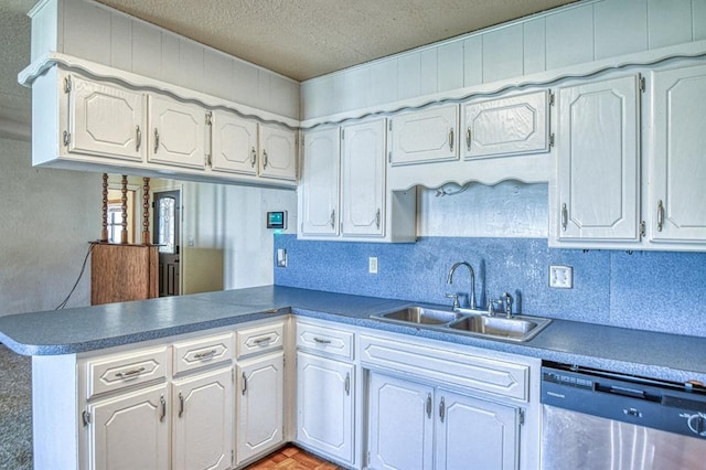 1110 Lollar Dr, Maysville, OK 73057 - kitchen featuring dishwasher, a sink, a peninsula, a textured ceiling, and tasteful backsplash