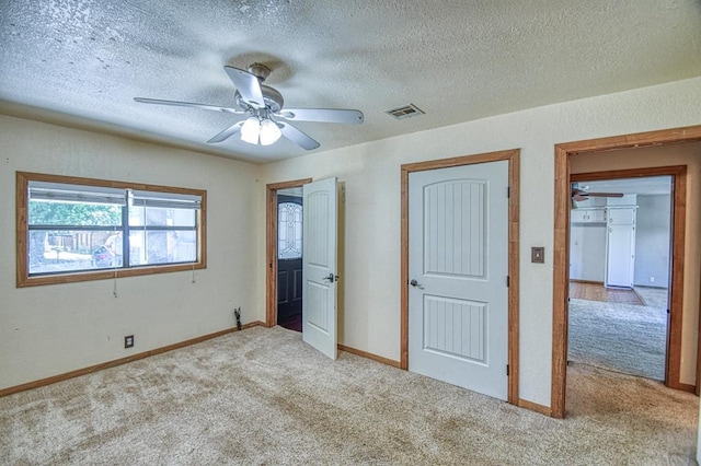 1110 Lollar Dr, Maysville, OK 73057 - unfurnished bedroom featuring carpet, a textured ceiling, baseboards, and ceiling fan
