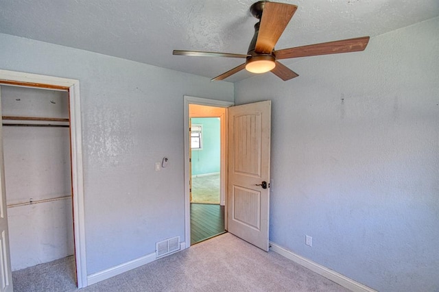 1110 Lollar Dr, Maysville, OK 73057 - unfurnished bedroom featuring carpet flooring, a closet, baseboards, and a ceiling fan