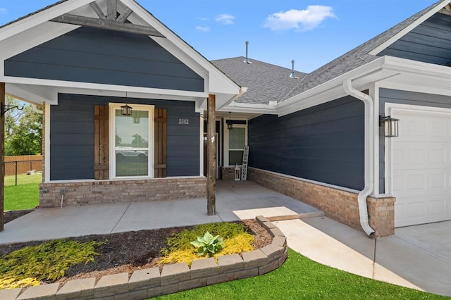 2382 County Road 1262, Blanchard, OK 73010 - view of front of home with an attached garage, a porch, roof with shingles, and brick siding