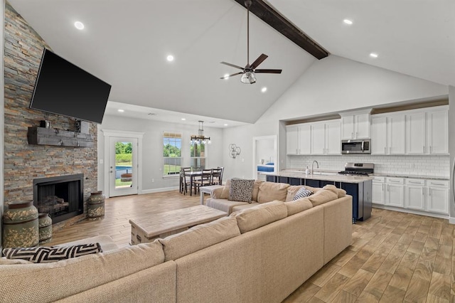 2382 County Road 1262, Blanchard, OK 73010 - living room featuring high vaulted ceiling, light wood-style flooring, ceiling fan, beamed ceiling, and a fireplace