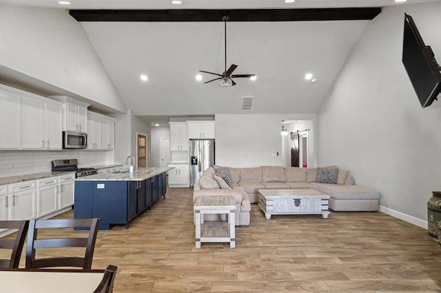 2382 County Road 1262, Blanchard, OK 73010 - living room with high vaulted ceiling, beam ceiling, a ceiling fan, light wood-style floors, and baseboards