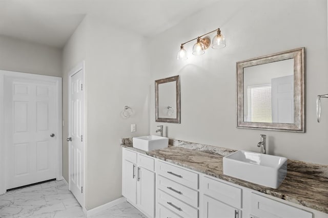 2382 County Road 1262, Blanchard, OK 73010 - full bathroom with marble look tiles, double vanity, and baseboards