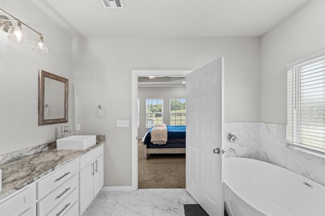 2382 County Road 1262, Blanchard, OK 73010 - ensuite bathroom featuring a freestanding bath, vanity, marble finish floors, and baseboards