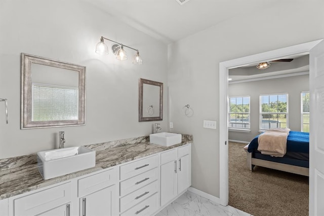 2382 County Road 1262, Blanchard, OK 73010 - bathroom with double vanity, baseboards, ensuite bath, marble look tiles, and a ceiling fan