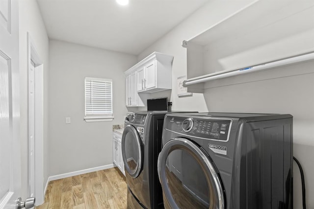 2382 County Road 1262, Blanchard, OK 73010 - laundry room featuring washer and clothes dryer, light wood-style floors, baseboards, and cabinet space