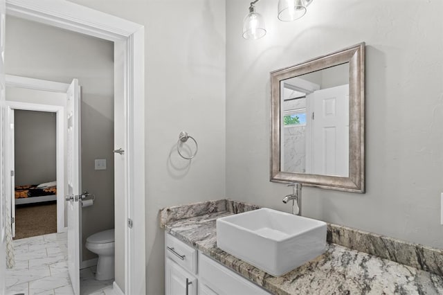 2382 County Road 1262, Blanchard, OK 73010 - ensuite bathroom featuring marble finish flooring, vanity, toilet, and baseboards