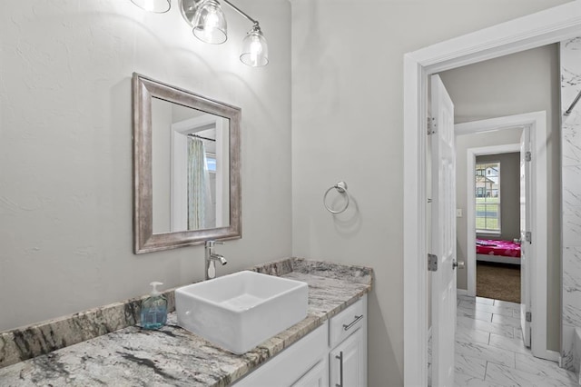 2382 County Road 1262, Blanchard, OK 73010 - bathroom with marble finish flooring, vanity, and baseboards