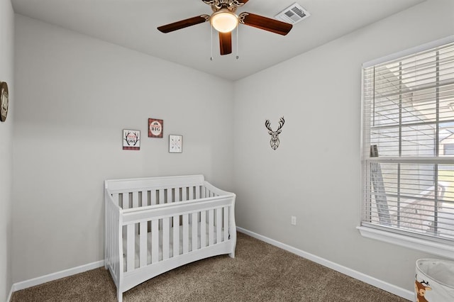 2382 County Road 1262, Blanchard, OK 73010 - carpeted bedroom with a crib, baseboards, and a ceiling fan