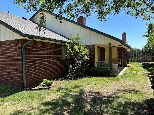 3113 Shannon Ct, Bethany, OK 73008 - back of house with a chimney, brick siding, a patio area, and a shingled roof