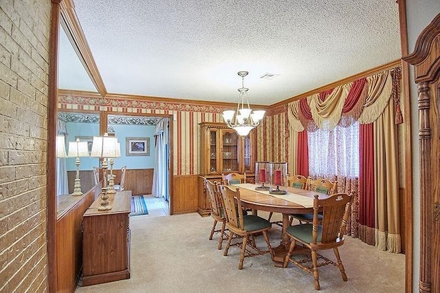 3113 Shannon Ct, Bethany, OK 73008 - carpeted dining room featuring a chandelier, ornamental molding, a textured ceiling, and wallpapered walls
