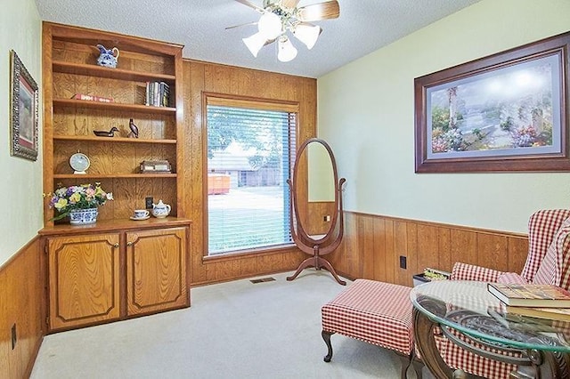3113 Shannon Ct, Bethany, OK 73008 - living area featuring wood walls, wainscoting, plenty of natural light, carpet flooring, and ceiling fan