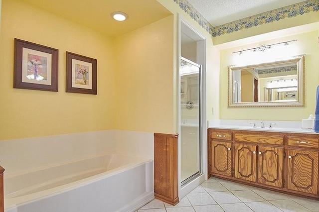 3113 Shannon Ct, Bethany, OK 73008 - bathroom featuring tile patterned floors, a bath, a shower stall, vanity, and a textured ceiling