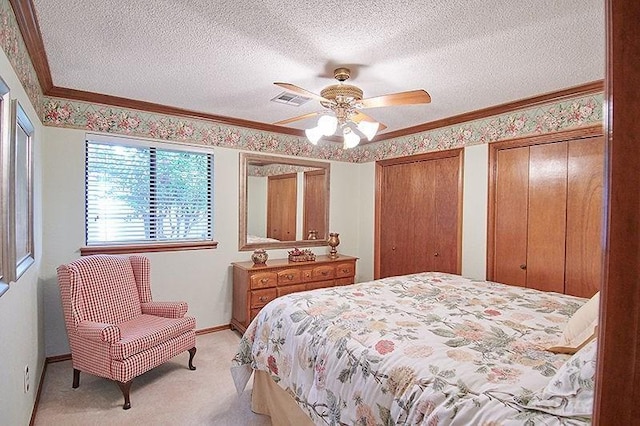 3113 Shannon Ct, Bethany, OK 73008 - bedroom with light colored carpet, a textured ceiling, multiple closets, baseboards, and ceiling fan