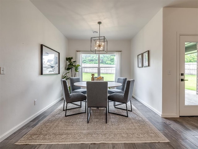2257 Preserve Edge Dr, Edmond, OK 73034 - dining space featuring a chandelier, dark wood finished floors, and baseboards