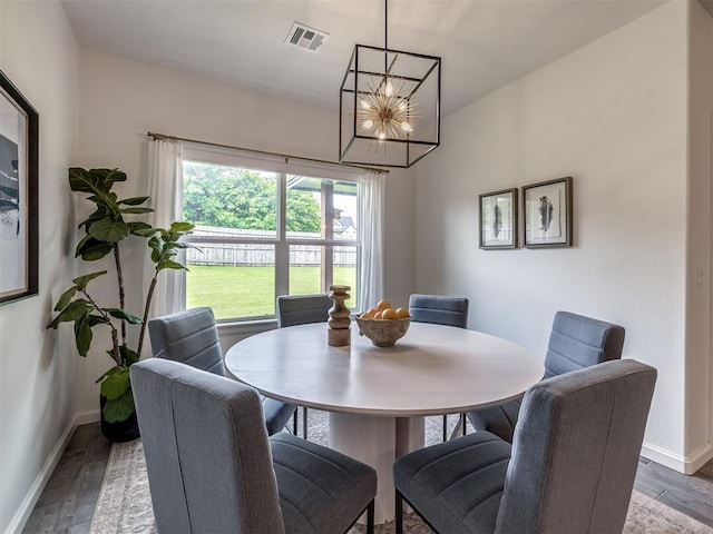 2257 Preserve Edge Dr, Edmond, OK 73034 - dining space featuring a chandelier, wood finished floors, and baseboards
