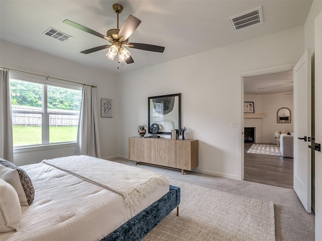 2257 Preserve Edge Dr, Edmond, OK 73034 - bedroom featuring carpet flooring, baseboards, a fireplace, and ceiling fan