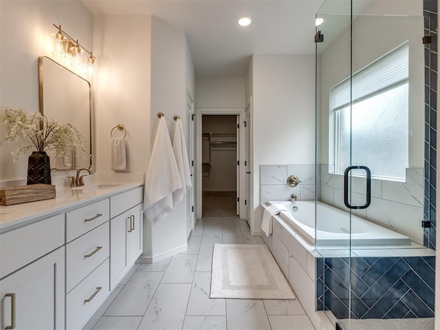 2257 Preserve Edge Dr, Edmond, OK 73034 - bathroom with vanity, marble look tile flooring, a walk in closet, a garden tub, and a shower stall