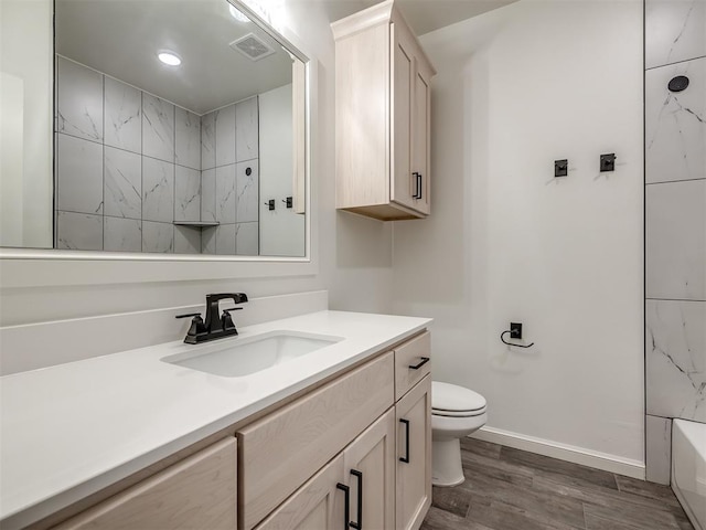 2257 Preserve Edge Dr, Edmond, OK 73034 - full bathroom with wood finished floors, vanity, toilet, a shower, and baseboards