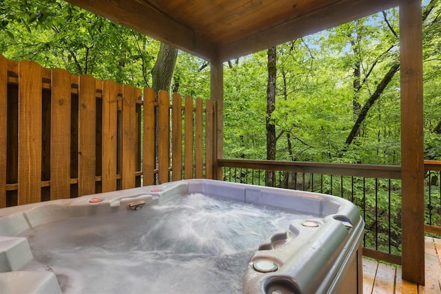 186 W Eagle Mountain Trl, Broken Bow, OK 74728 - wooden deck featuring a hot tub and a wooded view
