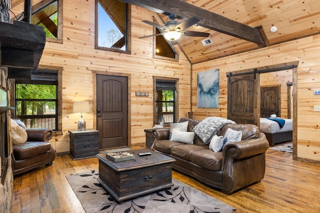 186 W Eagle Mountain Trl, Broken Bow, OK 74728 - living area with wood-type flooring, wood walls, ceiling fan, high vaulted ceiling, and a wooden ceiling with exposed beams