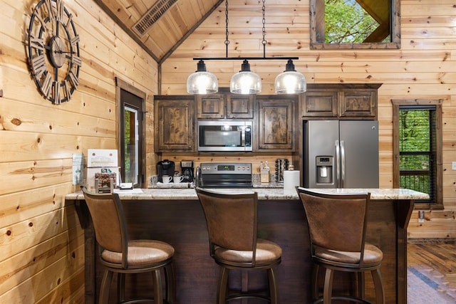 186 W Eagle Mountain Trl, Broken Bow, OK 74728 - kitchen featuring appliances with stainless steel finishes, wood walls, vaulted ceiling, wood ceiling, and dark brown cabinets