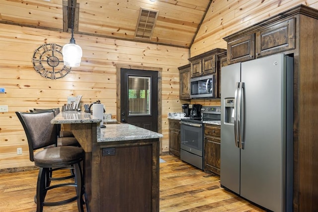 186 W Eagle Mountain Trl, Broken Bow, OK 74728 - kitchen with stainless steel appliances, lofted ceiling, wooden ceiling, light wood finished floors, and wood walls