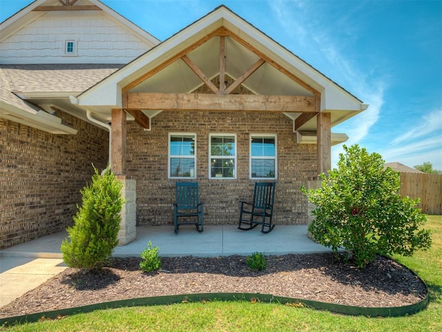 11052 NW 21st St, Yukon, OK 73099 - rear view of property featuring brick siding, a patio area, and roof with shingles