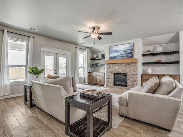 11052 NW 21st St, Yukon, OK 73099 - living area featuring a ceiling fan, a brick fireplace, baseboards, and light wood-style floors