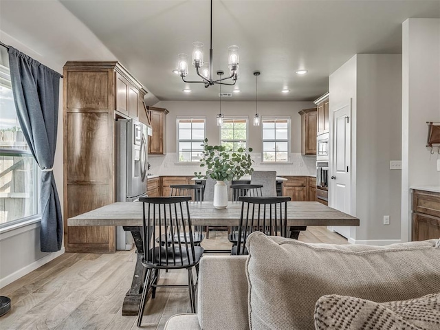 11052 NW 21st St, Yukon, OK 73099 - dining room with a chandelier, light wood finished floors, recessed lighting, and baseboards