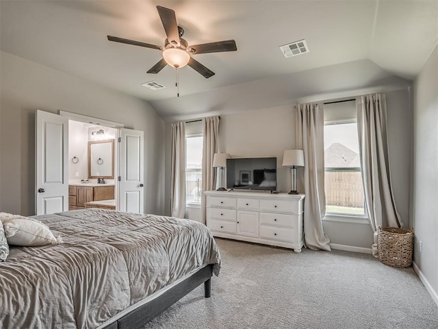 11052 NW 21st St, Yukon, OK 73099 - bedroom with vaulted ceiling, light colored carpet, baseboards, ensuite bath, and a ceiling fan