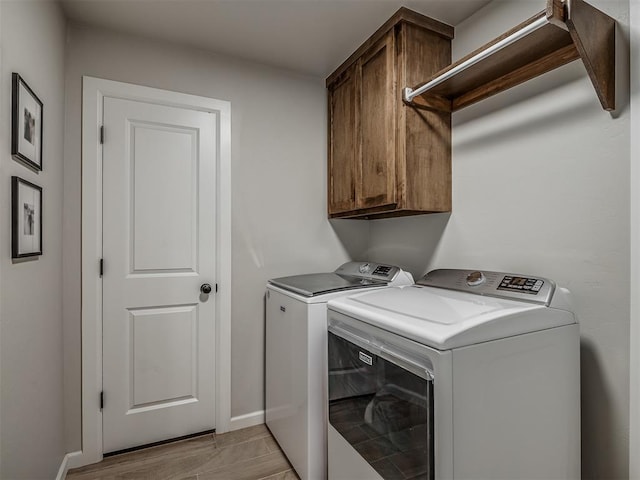 11052 NW 21st St, Yukon, OK 73099 - washroom with washer and dryer, cabinet space, and baseboards