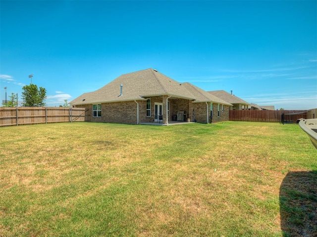 11052 NW 21st St, Yukon, OK 73099 - back of house with brick siding, a patio, and roof with shingles