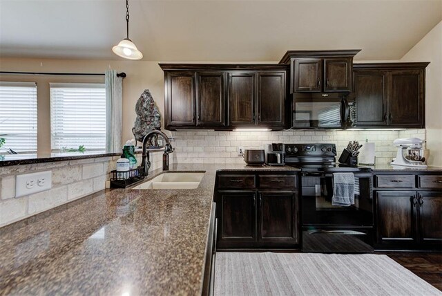 2345 NW 191st Ct, Edmond, OK 73012 - kitchen featuring black appliances, a sink, decorative backsplash, dark brown cabinetry, and lofted ceiling