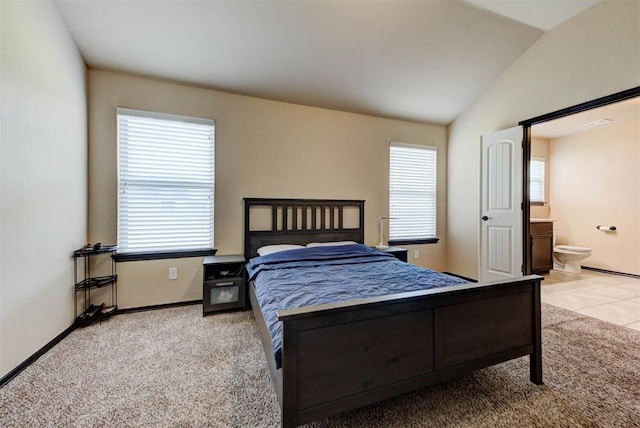 2345 NW 191st Ct, Edmond, OK 73012 - carpeted bedroom featuring vaulted ceiling, baseboards, and ensuite bathroom