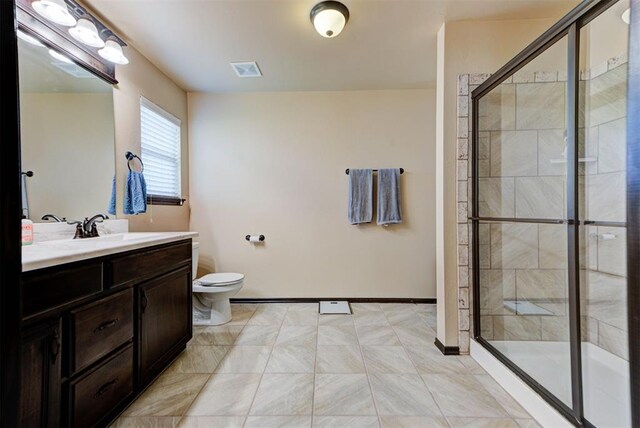 2345 NW 191st Ct, Edmond, OK 73012 - full bath with vanity, toilet, a shower stall, and baseboards