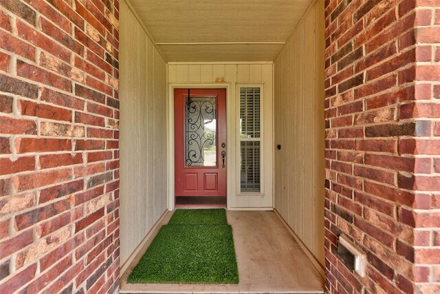 2345 NW 191st Ct, Edmond, OK 73012 - doorway to property with brick siding and covered porch