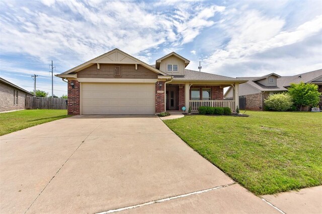 2345 NW 191st Ct, Edmond, OK 73012 - view of front facade with brick siding, an attached garage, concrete driveway, and a porch