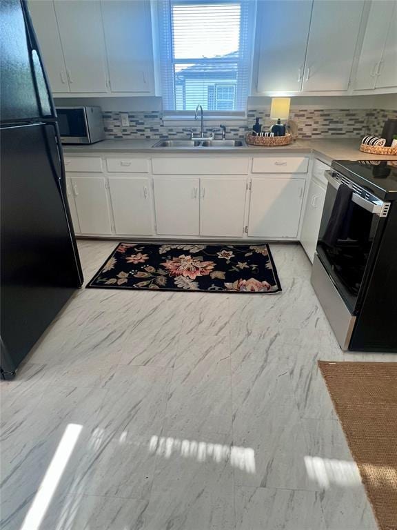414 N 1st St, Tecumseh, OK 74873 - kitchen with a sink, freestanding refrigerator, stainless steel microwave, electric stove, and tasteful backsplash