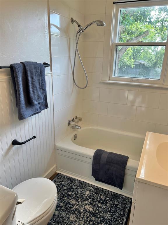 414 N 1st St, Tecumseh, OK 74873 - bathroom featuring toilet, bathing tub / shower combination, and vanity