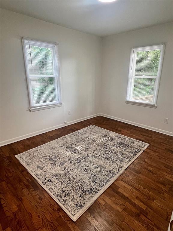 414 N 1st St, Tecumseh, OK 74873 - spare room with healthy amount of natural light and dark wood-type flooring