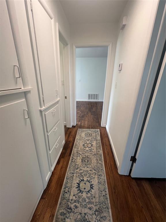 414 N 1st St, Tecumseh, OK 74873 - hallway with dark wood-style flooring and baseboards