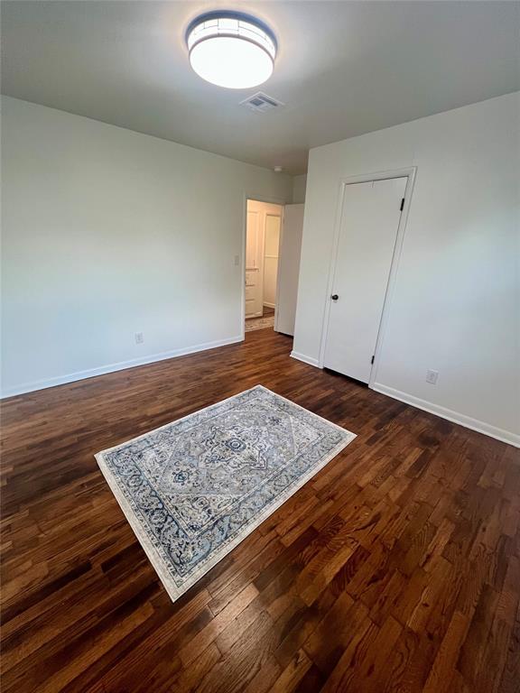 414 N 1st St, Tecumseh, OK 74873 - bedroom featuring baseboards and dark wood finished floors