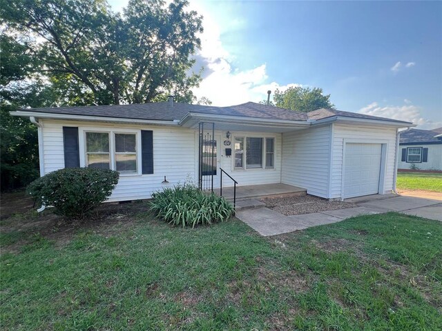 414 N 1st St, Tecumseh, OK 74873 - ranch-style home featuring a garage, driveway, a front yard, and a porch
